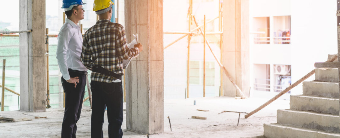 Asian contractor and engineer inspecting material in constructio Asian contractor and engineer inspecting material in construction building.
