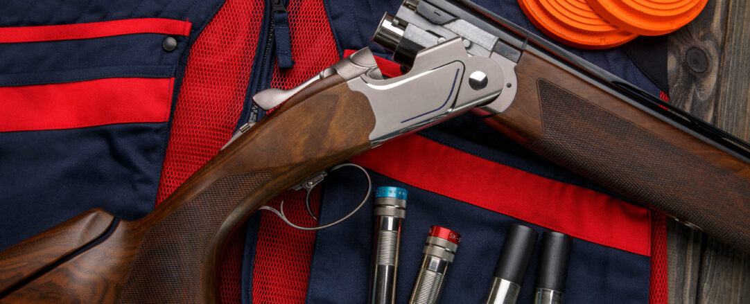 Clay target plates for shooting with rifle on wooden background.
