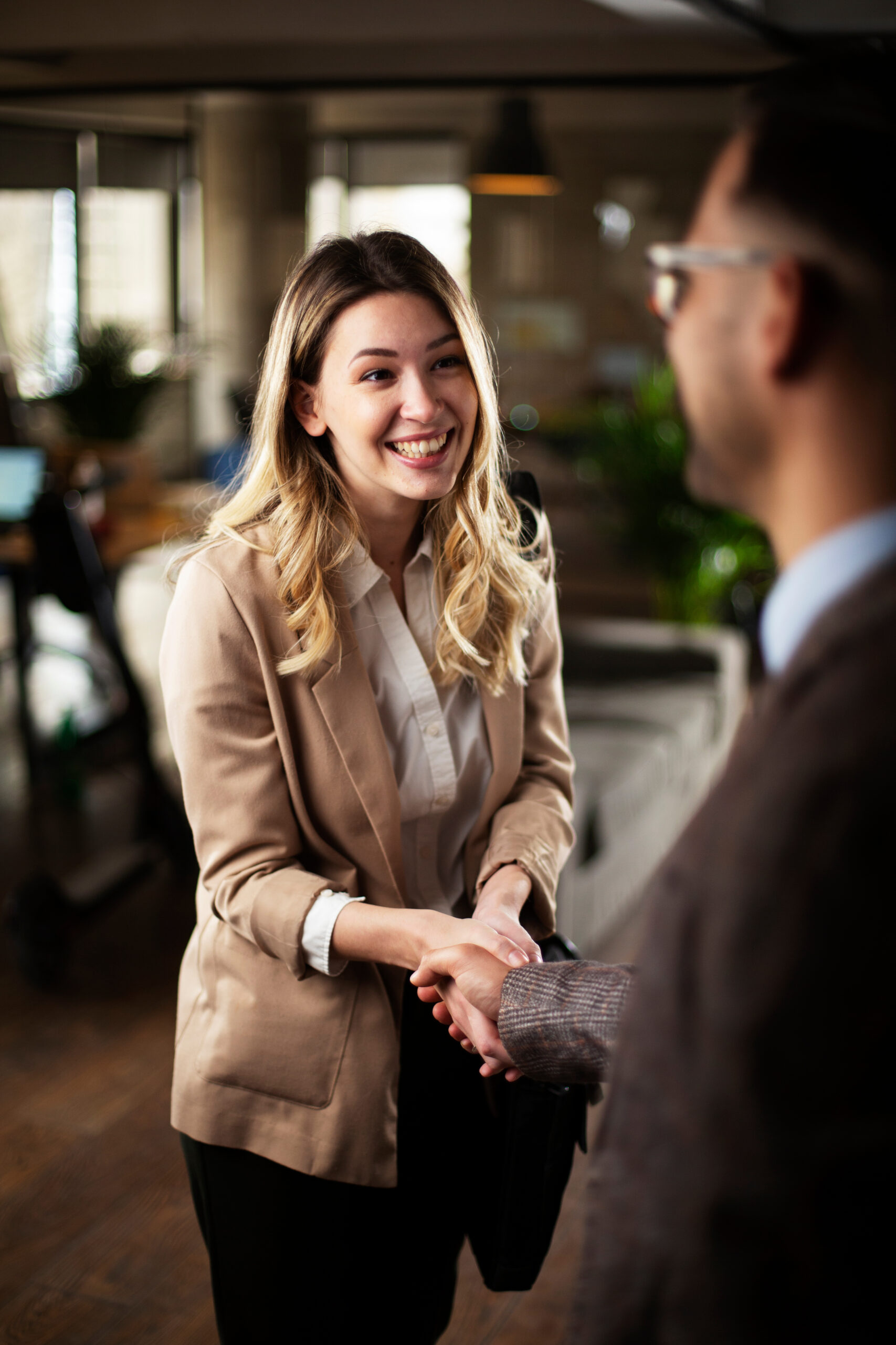 Businesswoman offering hand for handshake. Businessman and businesswoman handshake.